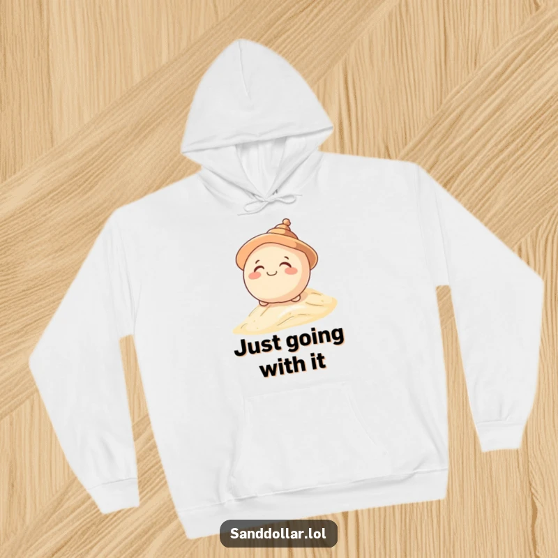 Funny hoodie featuring a giggling sand dollar character in a shell hat, rolling down a dune, offering warmth and playful humor.